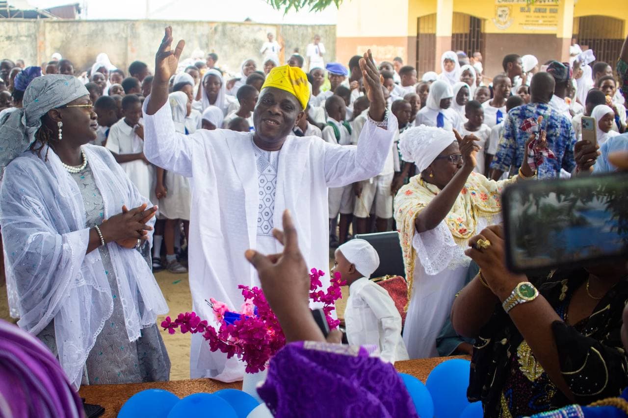 Comrade Ayeola at the school send-off with his two wives beside him