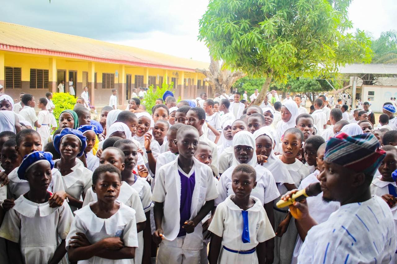 Pupils gathered closely around Comrade Ayeola during the school farewell